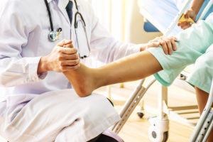 Orthopedic specialist examining a patient's painful foot