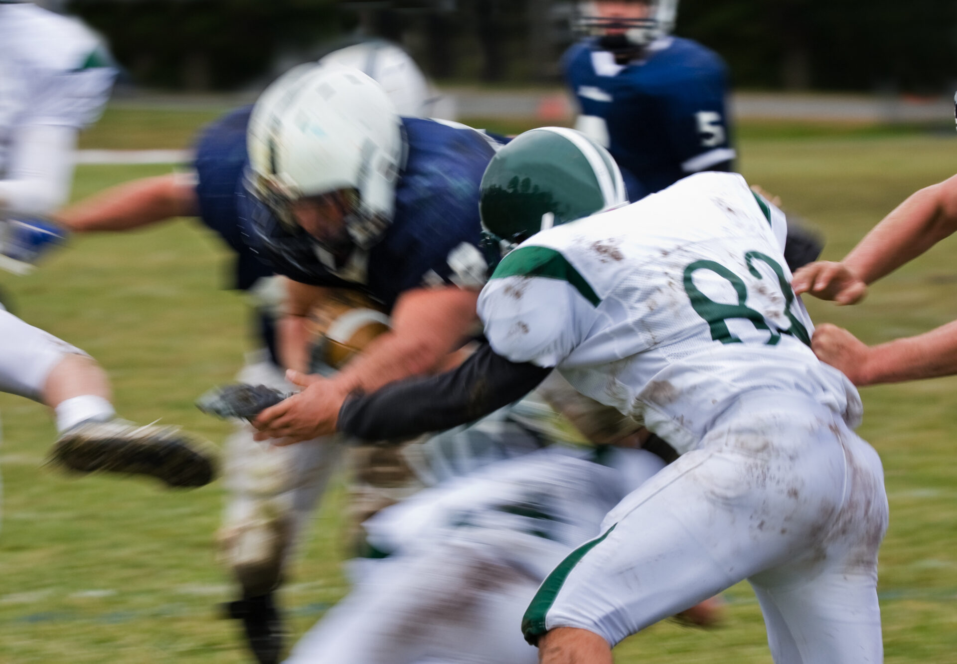 American Football player getting tackled. Common cause of shoulder instability and labral tear is direct blows to the shoulder