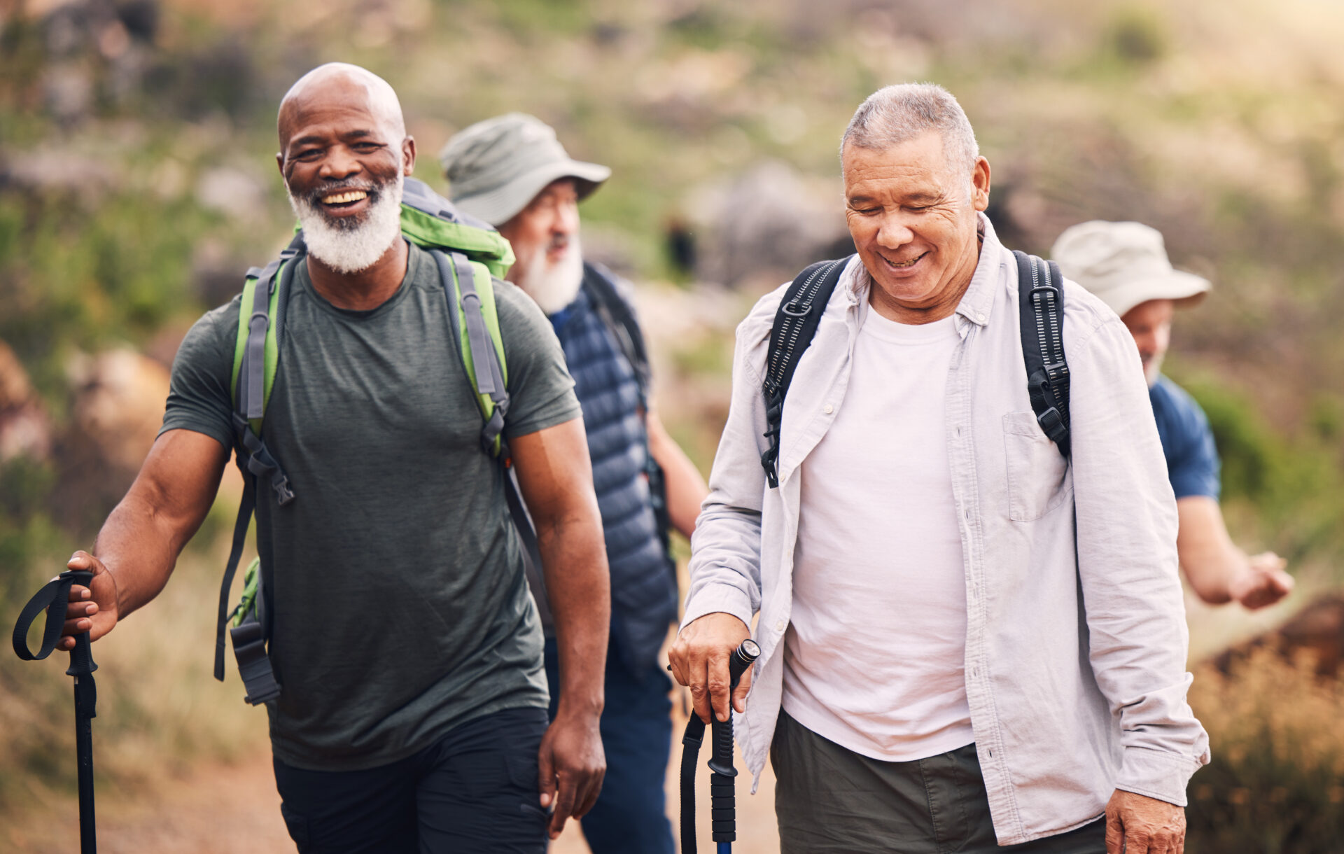 Friend group of elderly men on hiking trail. Men have recovered from total hip replacement surgery