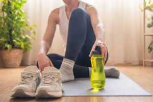 Water bottle and electrolyte drink on gym floor