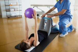 Patient performing supervised core strengthening exercise during women’s physical therapy in Manalapan NJ