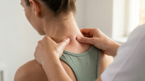 Chiropractor using manual therapy to address neck stiffness after a head or neck injury.