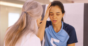 Healthcare provider evaluating an athlete with neck pain and concussion symptoms after a sports-related head injury.