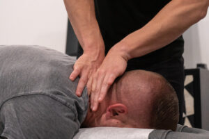 Chiropractor evaluating neck mobility in a patient after a head or neck injury.
